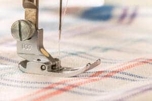 closeup sewing machine fabric empty space text