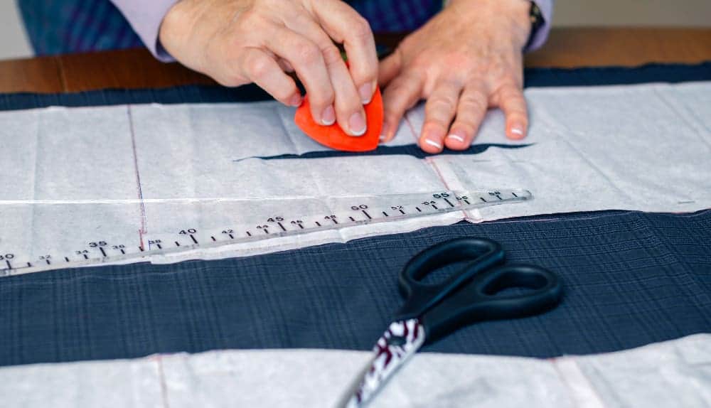 woman dressmaker design tailor pattern suit table