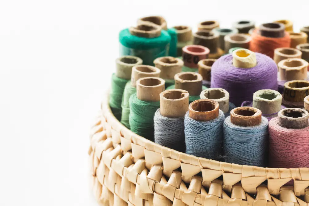 Can You Use Embroidery Thread On A Sewing Machine? 1 basket with sewing threads white background