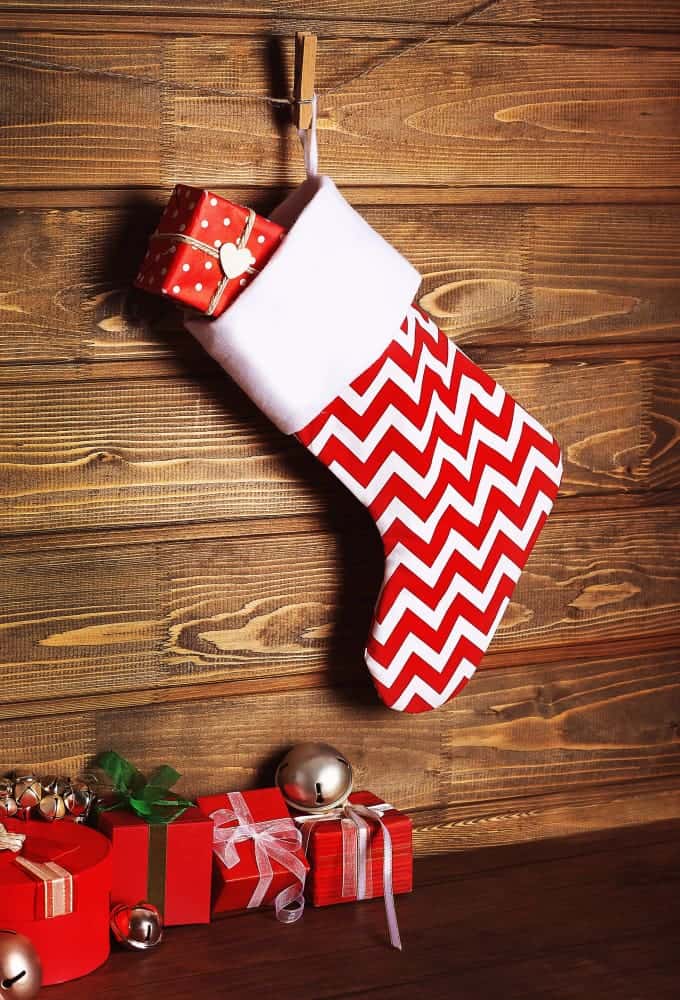How To Sew Names On Stockings for Chritsmas 2 christmas stocking presents against wooden wall 1