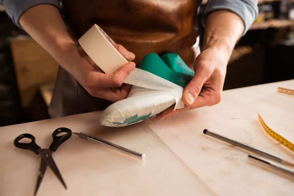 close up cobbler modeling mens shoe