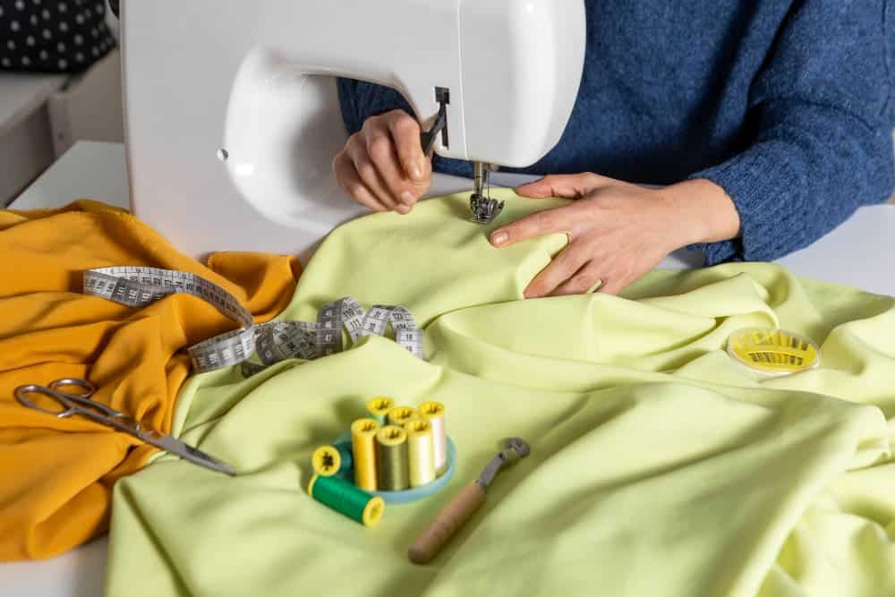 How To Make A Hoodie Smaller Without Sewing? 2 DIV Methods! 3 close up hands sewing with machine