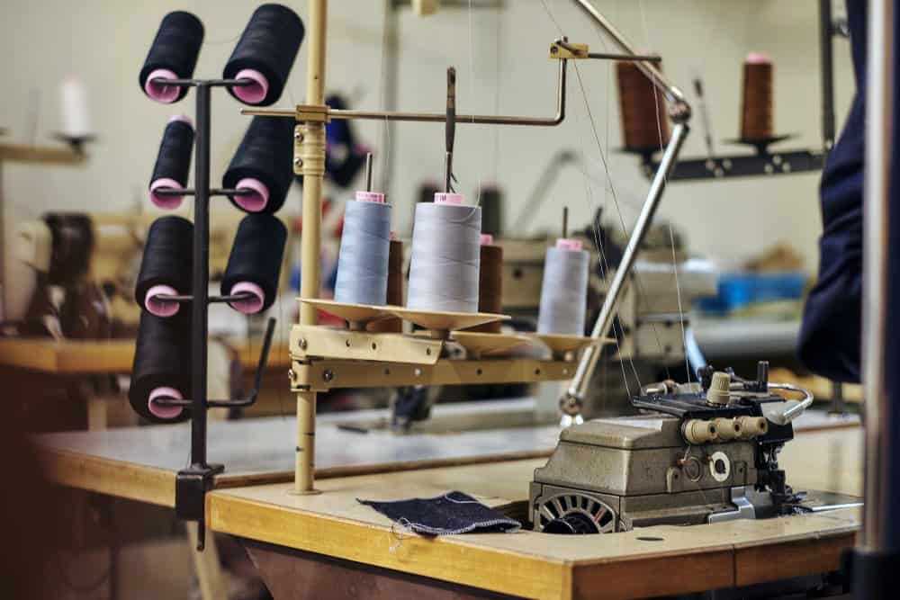 What Is A Mechanical Sewing Machine? 2 Reason Why People Choose Go With it! 2 close up image lot coils with threads sewing workshop