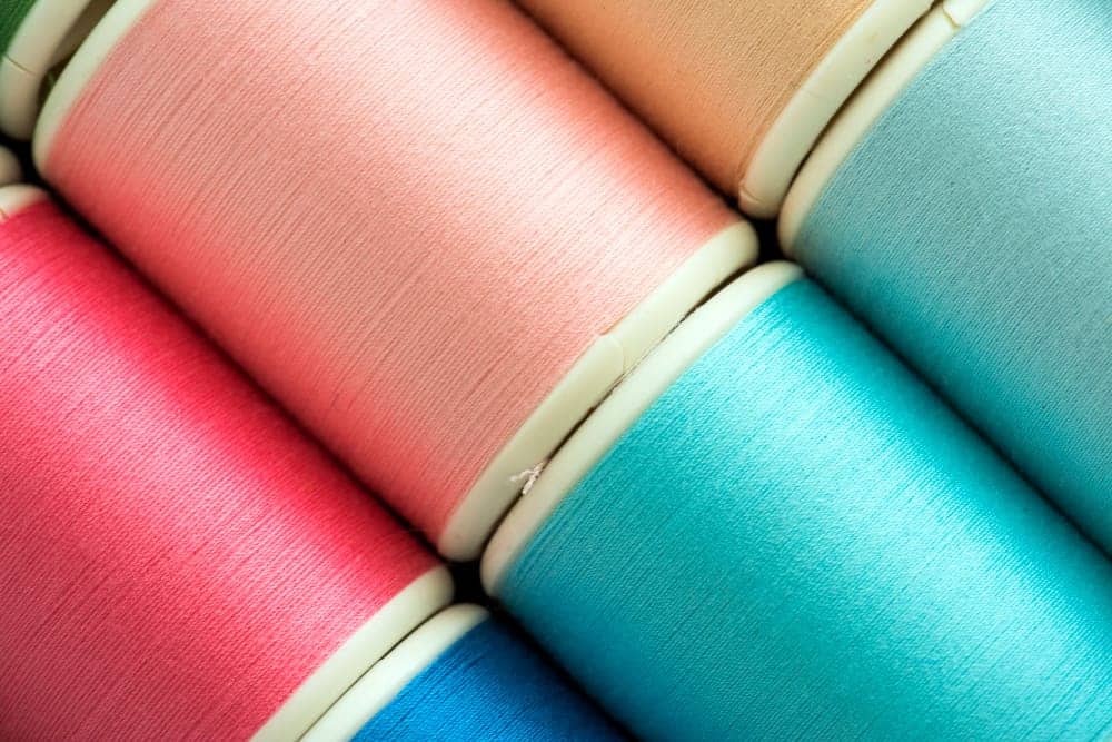 colorful sewing threads background closeup