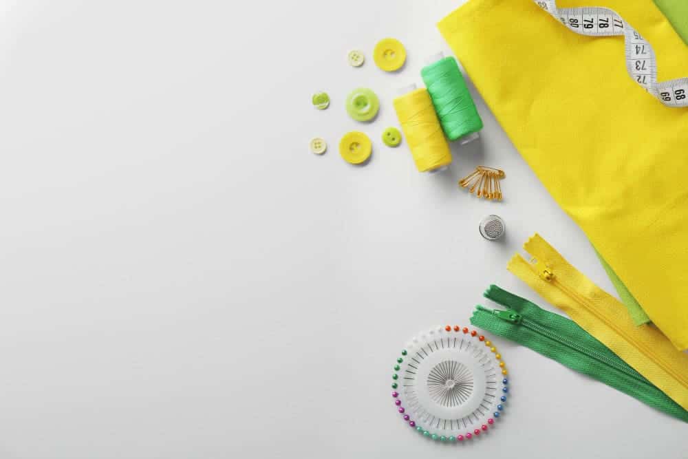 How To Make A Sash Without Sewing In 6 Easy Step? 3 composition with threads sewing accessories white background
