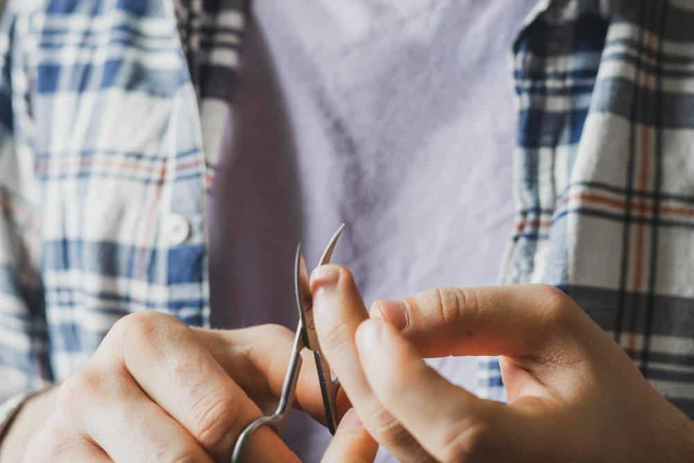 holding metal scissors cut nails personal health care 1