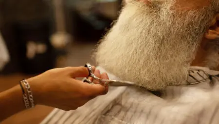 master makes beards correction barbershop salon close up photo