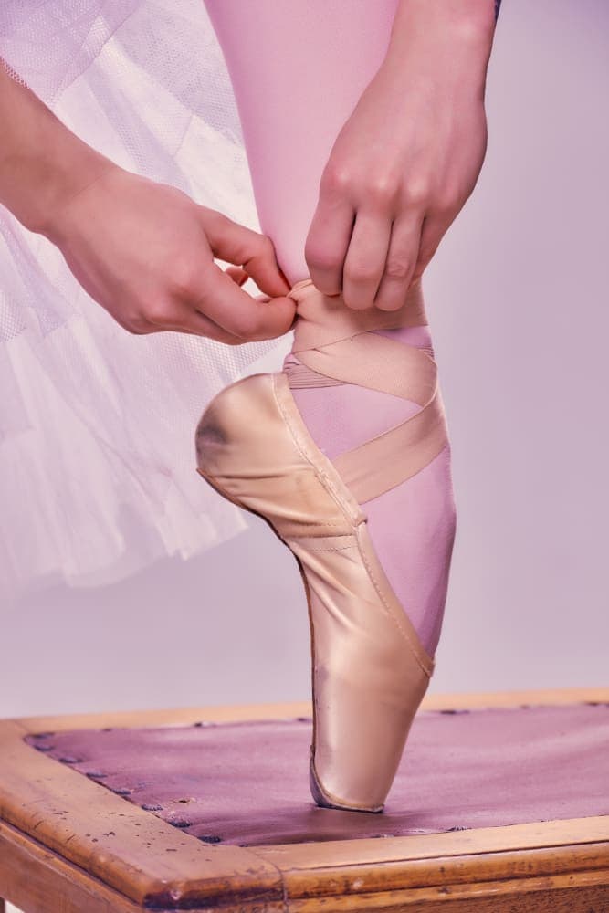 professional ballerina putting her ballet shoes 1