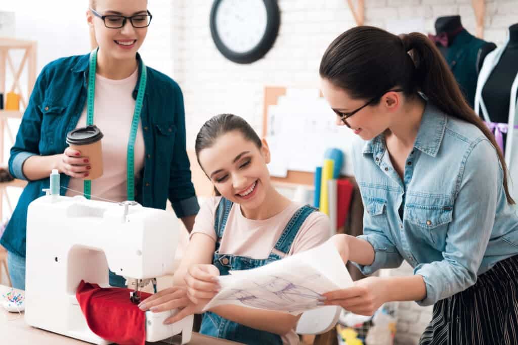 Are You A Student Wants To Teach A Friend How To Sew? Here's What You Do! 3 three women factory sew new clothes