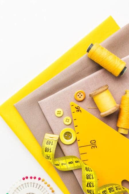 Demystifying What is Sewing Notions For Beginner top view fabrics with buttons thread