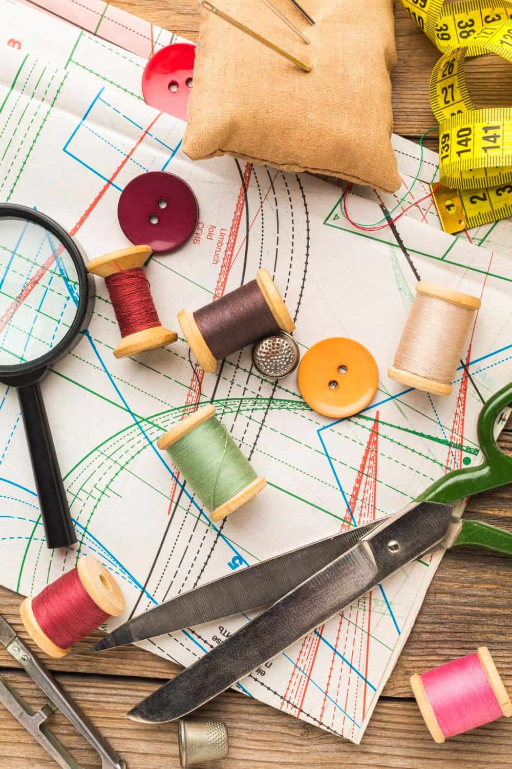 Demystifying What is Sewing Notions For Beginner 1 top view thread with magnifying glass scissors