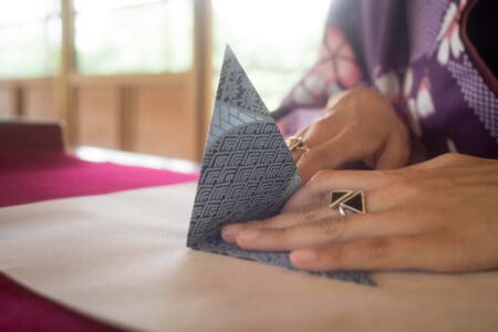 Why And How To Sew Triangles To A Square? 3 Amazing Benefits woman making origami with japanese paper