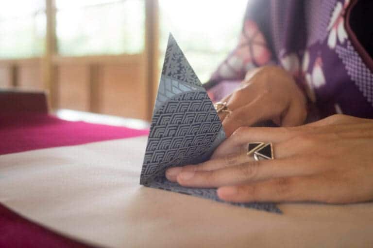 woman making origami with japanese paper